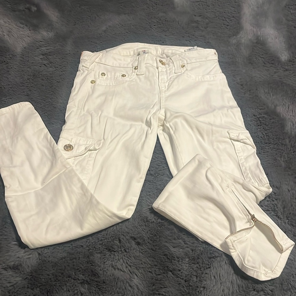 White true religion pants with gold zippers at the ankle